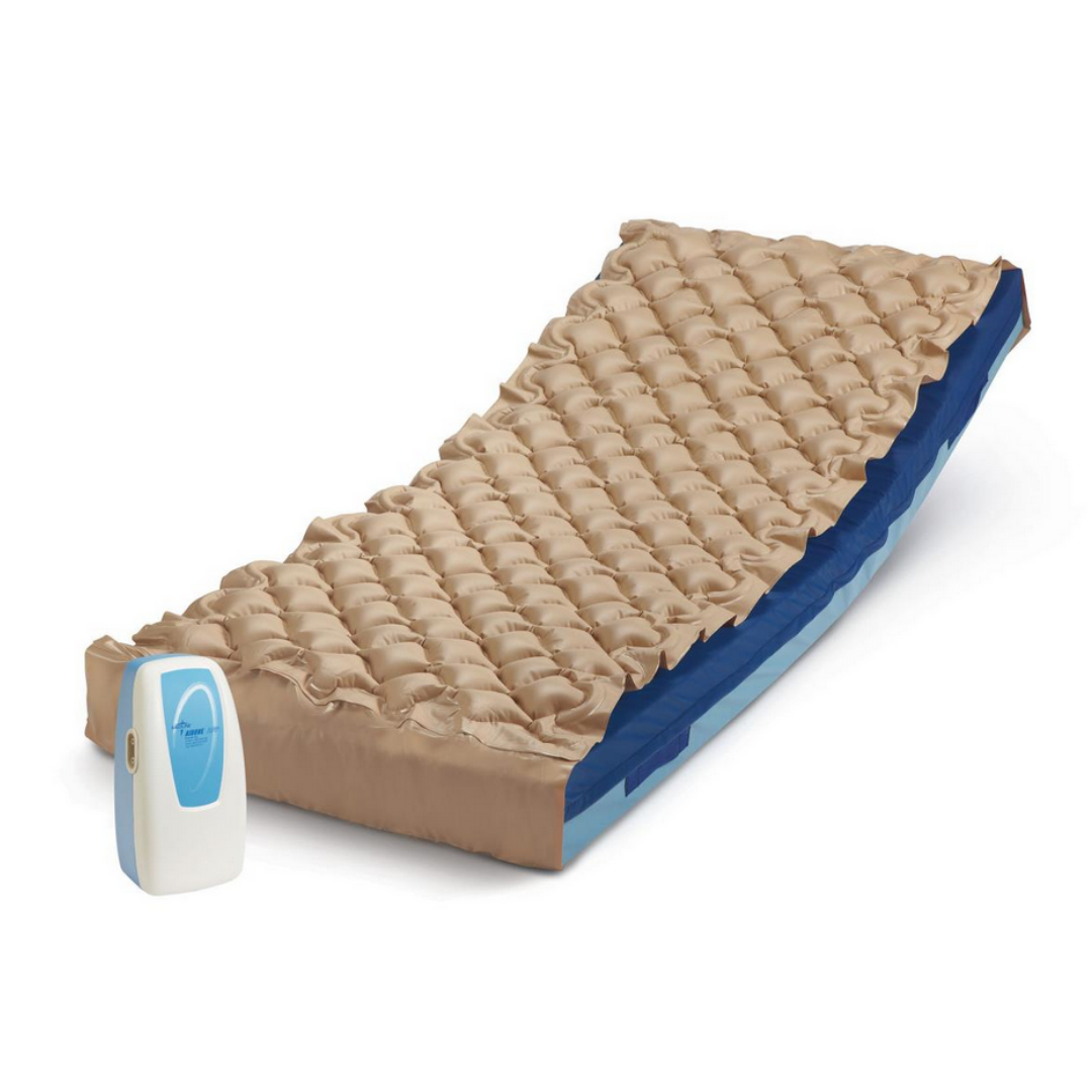 The Medline AirOne APP Alternating Pressure Pump and Pad features a beige, textured mattress with an anti-slip vinyl pad thats partially elevated. A compact white and blue whisper-quiet pump sits beside it for easy inflation.